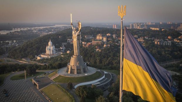 Workers install the Ukrainian coat of arms on the shield in the hand of the country's tallest stature, the Motherland Monument, after the Soviet coat of arms was removed, in Kyiv, Ukraine, Sunday, Aug. 6, 2023. Ukraine is accelerating efforts to erase the vestiges of centuries of Soviet and Russian influence from the public space amid the Russian invasion of Ukraine by pulling down monuments and renaming hundreds of streets to honor home-grown artists, poets, military chiefs, and independence leaders. (AP Photo/Efrem Lukatsky)
