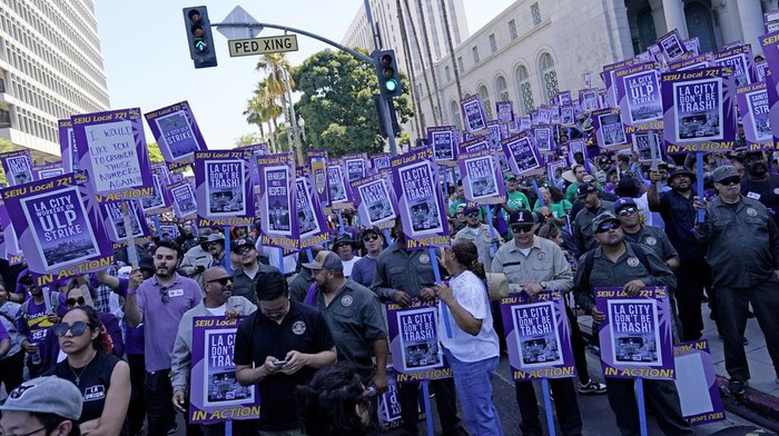 Workers picket outside of City Hall Tuesday, Aug. 8, 2023, in Los Angeles. Thousands of Los Angeles city employees, including sanitation workers, engineers and traffic officers, walked off the job for a 24-hour strike alleging unfair labor practices. The union said its members voted to authorize the walkout because the city has failed to bargain in good faith and also engaged in labor practices that restricted employee and union rights. (AP Photo/Ryan Sun)