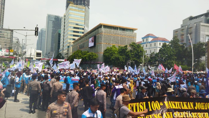 Massa buruh duduk blokade Jalan MH Thamrin menuju Patung Kuda.