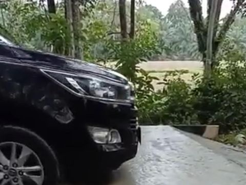 Mobil dinas melintasi jalan yang baru dicor di Musi Waras. (Foto: Istimewa)