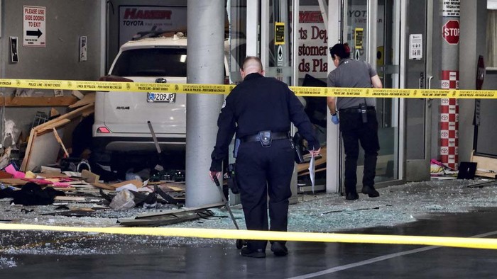 Potret Mobil Seruduk Dealer Toyota di Los Angeles Police investigators survey the scene of a vehicle crash at the service center for a Toyota Auto Dealership in the Mission Hills neighborhood of Los Angeles on Wednesday, Aug. 9, 2023. The vehicle driven by a customer entered the service area of dealership and struck a few people Wednesday, killing one of the injured who was briefly trapped beneath the vehicle, authorities and witnesses say. (AP Photo/Richard Vogel)