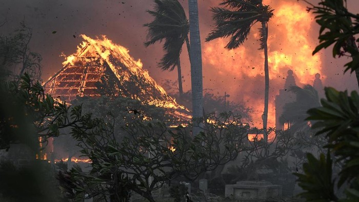 The hall of historic Waiola Church in Lahaina and nearby Lahaina Hongwanji Mission are engulfed in flames along Wainee Street on Tuesday, Aug. 8, 2023, in Lahaina, Hawaii. (Matthew Thayer/The Maui News via AP)