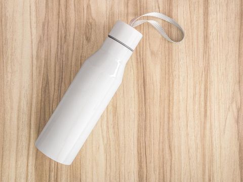 White water bottle on wood background. Insulated container for keep your drink.