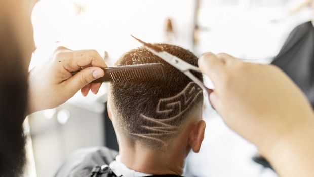 Hairdresser working in barber shop