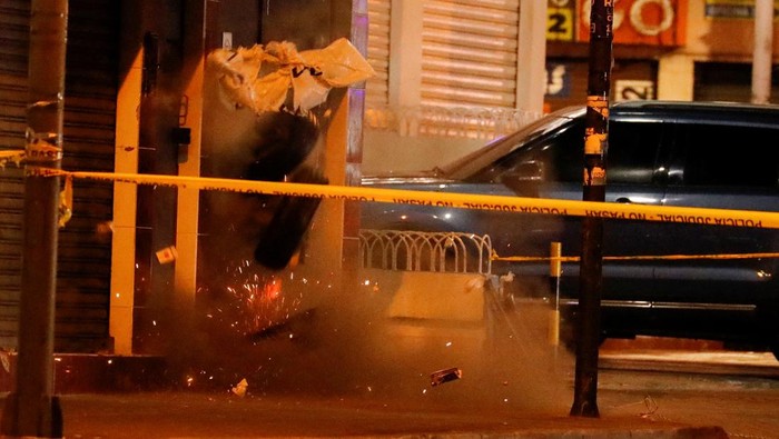 A security officer conducts a controlled explosion of an explosive device left outside the rally site where Ecuadorean presidential candidate Fernando Villavicencio was killed at a campaign event in Quito, Ecuador August 9, 2023. REUTERS/Karen Toro