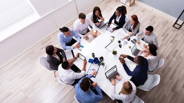 Group Of Multi Ethnic Business Team Sitting Together At Workplace In Modern Office