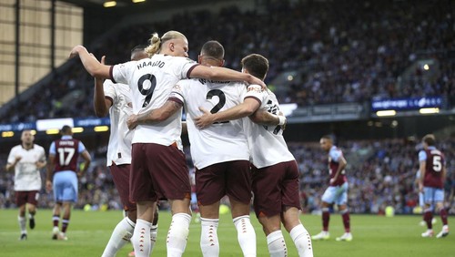 Manchester Citys Erling Haaland celebrates scoring their sides second goal of the game with team-mates during the Premier League soccer match between Manchester City and Burnley FC at Turf Moor, Burnley, England, Friday Aug. 11, 2023. (Nigel French/PA via AP)