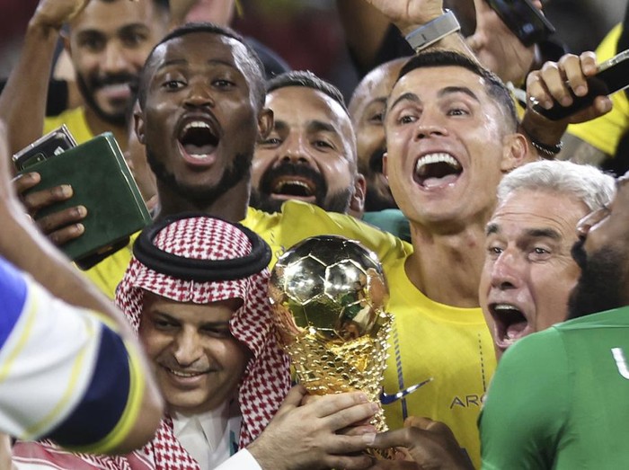 Al Nassr's Cristiano Ronaldo, and teammates celebrate with the trophy of the Arab Club Championship Cup at King Fahd Stadium in Taif, Saudi Arabia, Saturday, Aug.12, 2023. (AP Photo/Samah Zidan)