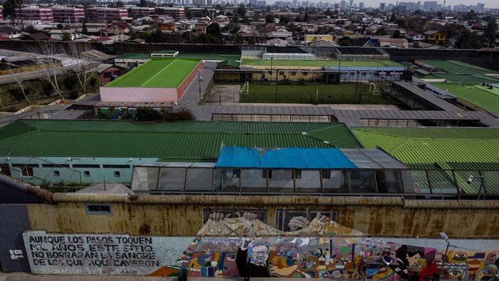 Mantan tahanan politik di Santiago melakukan restorasi mural mattan presiden Salvador di Santiago. Begini potretnya.