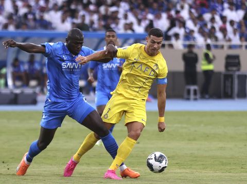 Al-Nassr's Cristiano Ronaldo, right, fights for the ball against Al-Hilal's Kalidou Koulibaly during the Arab Club Champions Cup between Al-Nassr and Al-Hilal at King Fahd Stadium in Taif, Saudi Arabia, Saturday, Aug. 12, 2023. (AP Photo/Samah Zidan)