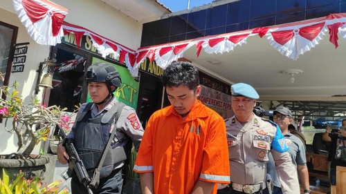 I Nengah Juliana tertunduk lesu saat digiring untuk konferensi pers di Polsek Denpasar Timur, Senin (14/8/2023).