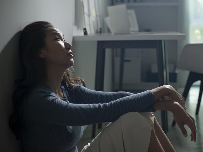Young Asian woman sitting on floor at home feeling sad tired and worried suffering depression in mental health, problems and broken heart concept, life difficulties