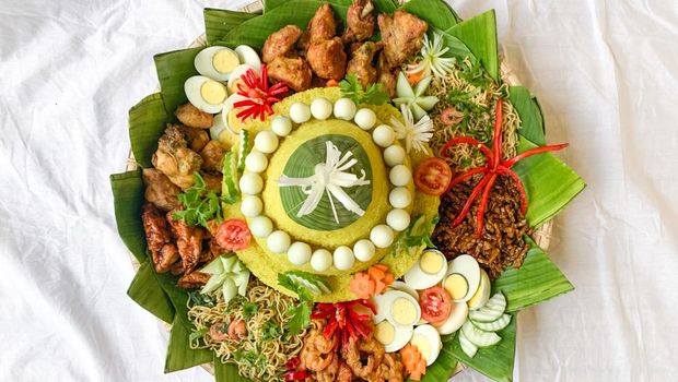 Traditional dish named Nasi Tumpeng, yellow rice cone shape with various side dish around. Usually served to celebrate birthdays or anniversary and formal events in Indonesia.