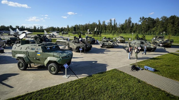 Journalists visit an exhibition of tanks and APCs of Ukrainian armed forces damaged and captured during the fighting in Ukraine at the International Military Forum Army-2023 in the Patriot Park near Moscow in Moscow, Russia, Tuesday, Aug. 15, 2023.(AP Photo/Alexander Zemlianichenko)