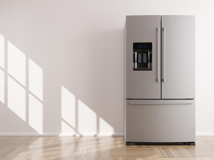 Refrigerator standing in empty room. Free, copy space for text or other objects. Household electrical equipment. Modern kitchen appliance. Stainless steel fridge with double doors, freezer. 3d render