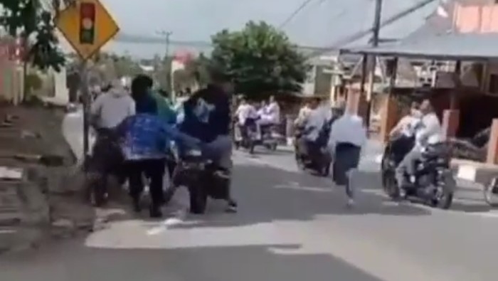 Aksi guru menghentikan pelajar yang menggeber sepeda motor di depan SMAN 2 Karimun viral. (Foto: Tangkapan layar)