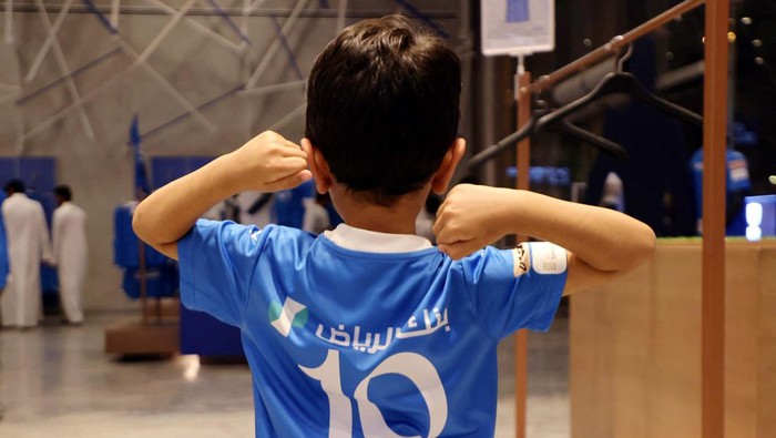 Soccer Football - Neymar signs for Al Hilal - Riyadh, Saudi Arabia - August 15, 2023
A young fan poses wearing a Neymar Al Hilal shirt in the club shop
REUTERS/Ahmed Yosri