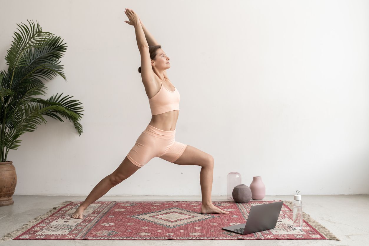 Woman practicing Yoga Reverse Warrior pose