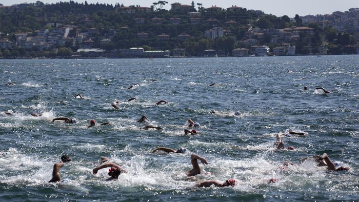 Competitors travel to the start line of a 6.5km swimming race across the Bosporus Strait, from the Asian side to the European side, in Istanbul, Turkey, Sunday, Aug. 20, 2023. (AP Photo/Khalil Hamra)