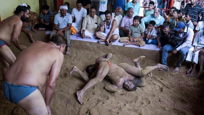 Traditional Indian wrestlers engage in a bout during Nag Panchami festival in Prayagraj, India, Monday, Aug. 21, 2023. Every year, the wrestlers offer prayers and hold bouts to mark the festival which is primarily dedicated to the worship of snakes. (AP Photo/Rajesh Kumar Singh)