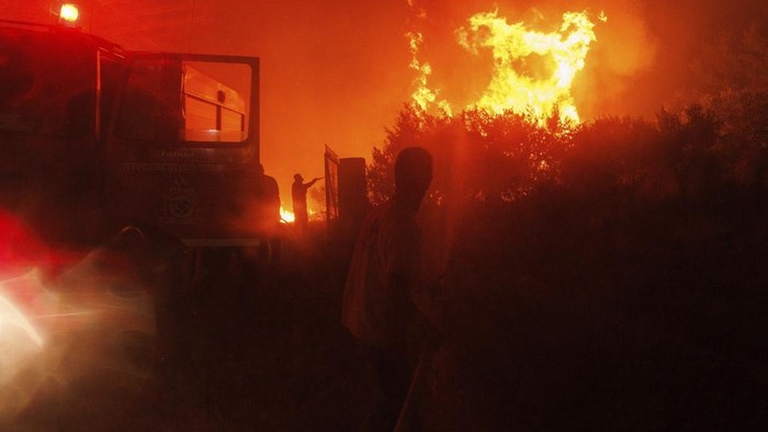 Was-was Warga Yunani Terkepung Kebakaran Hutan A local resident watches the wildfire in Avantas village, near Alexandroupolis town, in the northeastern Evros region, Greece, Monday, Aug. 21, 2023. Gale-force winds are fanning the flames of wildfires across Greece, including 53 new blazes that broke out early Monday amid hot, dry and windy weather that has sucked moisture from vegetation. (AP Photo/Achilleas Chiras)
