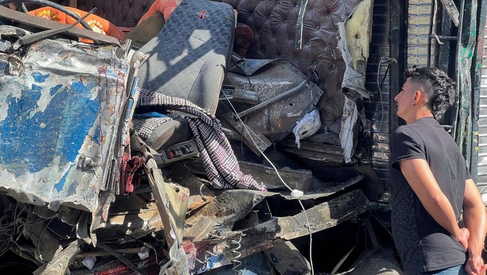 SENSITIVE MATERIAL. THIS IMAGE MAY OFFEND OR DISTURB A man observes the wreckage of a truck that crashed with a bus, in a road accident which left over a dozen passengers dead, in Tepelmeme Villa de Morelos, in Oaxaca state, Mexico August 22, 2023. REUTERS/Jose de Jesus Cortes REFILE - CORRECTING FROM 