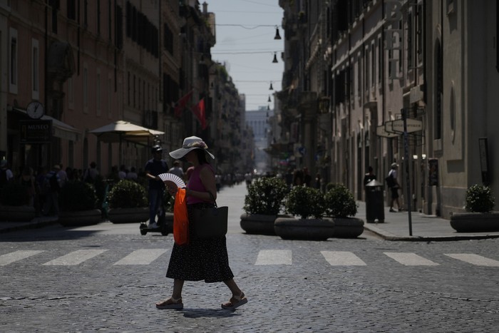 A man cools off at the Spanish Steps Barcaccia fountain in Rome, Tuesday, Aug. 22, 2023. Italy is facing a heat wave with temperatures in the capital as high as 37 Celsius (98 Farenheit). (AP Photo/Gregorio Borgia)