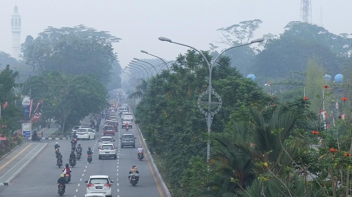 Sejumlah pengendara melintasi Jalan Ahmad Yani yang diselimuti asap di Pontianak, Kalimantan Barat, Rabu (23/8/2023). Berdasarkan pantauan BMKG per 22 Agustus 2023, terdapat 180 titik panas yang terdeteksi di empat kabupaten di Kalimantan Barat yaitu Ketapang, Kayong Utara, Melawi dan Kubu Raya. ANTARA FOTO/Jessica Wuysang/rwa.