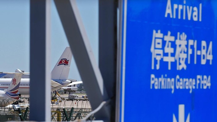 Ground crew work near an Air Koryo commercial plane on the tarmac at the Beijing Capital International Airport in Beijing, Tuesday, Aug. 22, 2023. A North Korean commercial flight has landed in Beijing amid signs that Pyongyang is opening borders again after almost three years of COVID-19 restrictions. (AP Photo/Andy Wong)