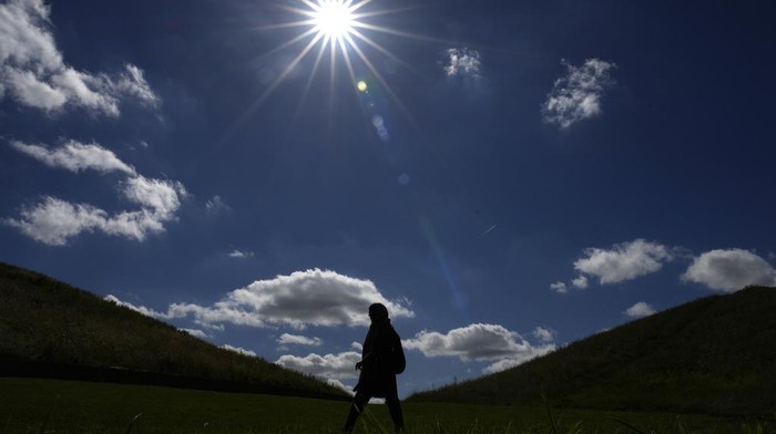 People stand on top of a mound in Northala Fields Country Park in London, Monday, Aug. 21, 2023. Northala fields is a country park that consists of ponds and four large earth mounds built using waste from the original Wembley Stadium and the building of the White City Westfield shopping centre. The mounds help to reduce noise pollution, provide a view point and are an interesting landmark for the area in west London. (AP Photo/Kirsty Wigglesworth)