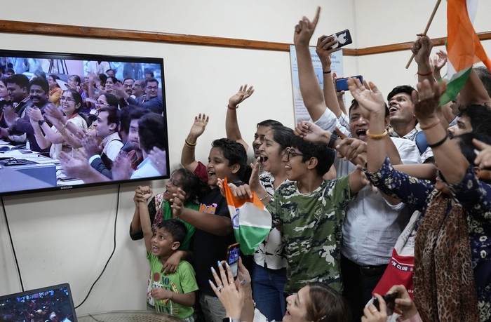 Schoolchildren cheer as they watch the successful landing of Chandrayaan-3, or “moon craft” in Sanskrit, at the Nehru Planetarium in New Delhi, India, Wednesday, Aug. 23, 2023. India has landed a spacecraft near the moon’s south pole, an unchartered territory that scientists believe could hold vital reserves of frozen water and precious elements, as the country cements its growing prowess in space and technology. (AP Photo/Manish Swarup)