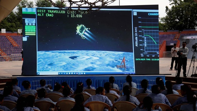 Arun Haryani, an enthusiast with his body painted in tri-colours reacts as he holds up a model of LVM3 M4 which was used in launching of Chandrayaan-3 spacecraft on the eve of its moon landing, in Ahmedabad, India, August 22, 2023. REUTERS/Amit Dave     TPX IMAGES OF THE DAY