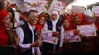 Gubernur Jawa Timur Khofifah Indar Parawansa (ketiga kanan) didampingi Dirut Bank Jatim Busrul Iman (kedua kiri) berfoto dengan buruh pabrik rokok penerima Bantuan Langsung Tunai (BLT) di Surabaya, Jawa Timur, Kamis (24/8/2023).