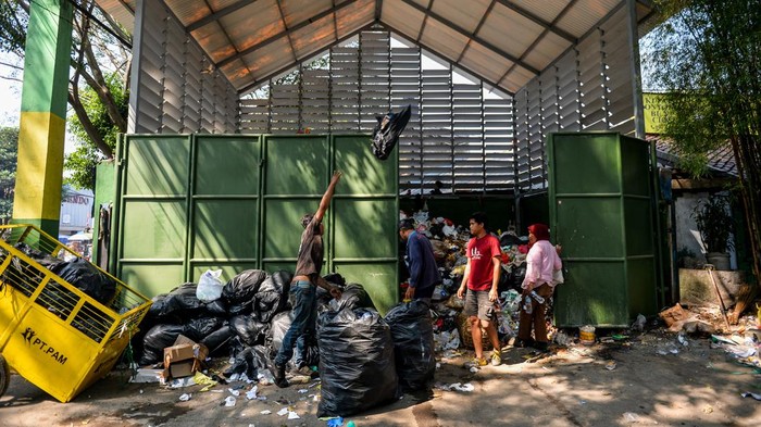 Ribuan Ton Sampah Kota Bandung Numpuk Imbas Kebakaran TPA Sarimukti Warga melintas di samping sampah yang menumpuk di TPS Pasar Ancol, Bandung, Jawa Barat, Kamis (24/8/2023). Dinas Lingkungan Hidup Kota Bandung menyatakan, ribuan ton sampah dari Kota Bandung tidak bisa dikirim ke TPA Sarimukti untuk sementara imbas dari terjadinya kebakaran TPA yang hingga saat ini masih terjadi. ANTARA FOTO/Raisan Al Farisi/foc.
