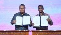 Gubernur Bank Indonesia Perry Warjiyo (kiri) bersama Gubernur Bank Negara Malaysia Abdul Rasheed Ghaffour menunjukan berkas kesepakatan kerja sama (MoU) di Jakarta, Jumat (25/8/2023). ANTARA FOTO/Hafidz Mubarak A.  