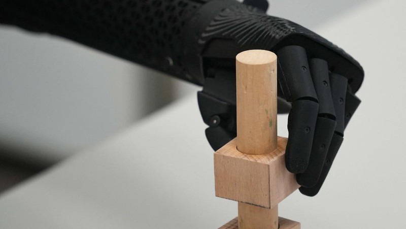 Orthopaedic technician Mike Unmacht of medical supplies company Lammert Scherer holds the bionic arm for Dominika Frycz, who received her new Open Bionics arm, among the first of its kind funded through health insurance and created with 3d printing, in Mainz, Germany, August 18, 2023. The 25-year-old who was born without a lower left arm had a bionic arm in the past, but decided against it because the weight of the arm and very limited movement caused more problems than it solved.  REUTERS/Max Schwarz