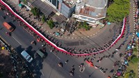 Foto udara sejumlah peserta membawa bendera saat mengikuti Kirab Merah Putih di Pekalongan, Jawa Tengah, Senin (28/8/2023).  