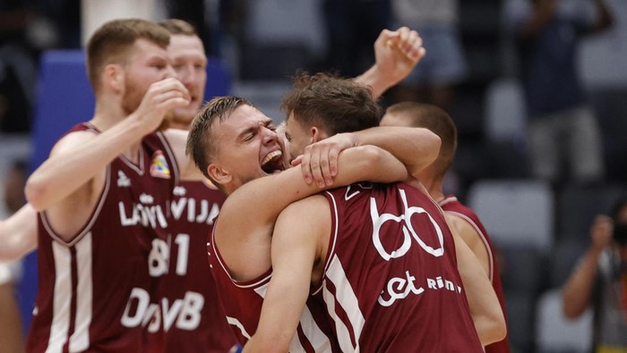 Basketball - FIBA World Cup 2023 - First Round - Group H - France v Latvia - Indonesia Arena, Jakarta, Indonesia - August 27, 2023 Latvias Kristers Zoriks celebrate with teammates after the match REUTERS/Willy Kurniawan