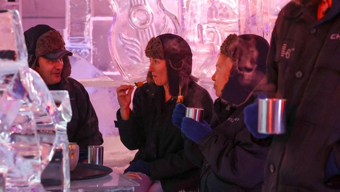 Guests enjoy warm beverages in freezing temperatures while visiting Chillout Ice Lounge in Dubai, United Arab Emirates, August 28, 2023. REUTERS/Amr Alfiky