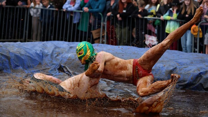Wrestlers Joe Blashill and El Bisto take part in the World Gravy Wrestling Championships at the Rose 'N' Bowl pub in Stacksteads, Britain, August 28, 2023. REUTERS/Phil Noble