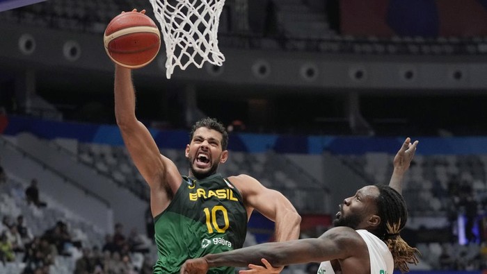 Brazil forward Tim Soares (10) shoots over Ivory Coast forward Amadou Sidibe (3) during the Basketball World Cup group G match between Brazil and the Ivory Coast at the Indonesia Arena stadium in Jakarta, Indonesia, Wednesday, Aug. 30, 2023. (AP Photo/Achmad Ibrahim)