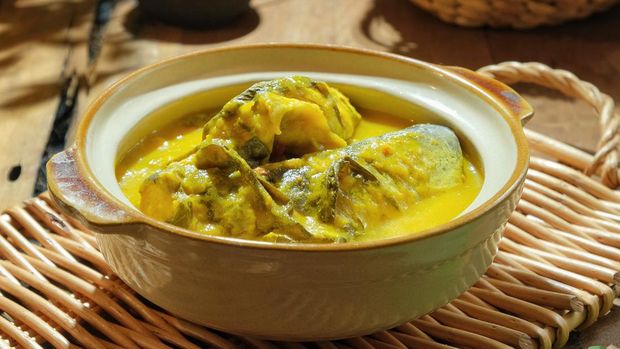 Ikan Patin Masak Tempoyak in a pot Ikan. Patin Tempoyak is a famous Malaysian heritage dish and it taste spicy.