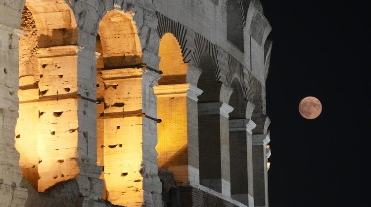A supermoon rises over the Colosseum in Rome, Wednesday, Aug. 30, 2023. (AP Photo/Gregorio Borgia)