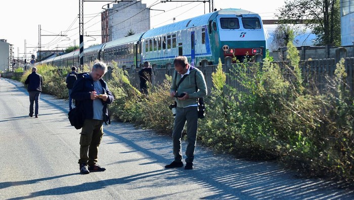 Members of the media work at the site of a train accident in which workers were killed, in Brandizzo, Italy, August 31, 2023. REUTERS/Massimo Pinca
