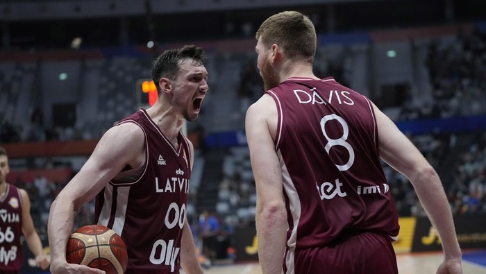 Latvia forward Rodions Kurucs (00) and Latvia forward Davis Bertans (8) react after scoring during the Basketball World Cup second round match between Spain and Latvia at the Indonesia Arena stadium in Jakarta, Indonesia, Friday, Sept. 1, 2023. (AP Photo/Achmad Ibrahim)