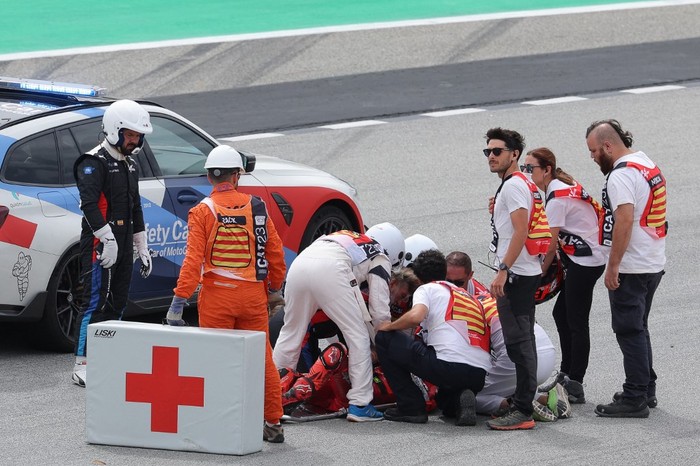 Ducati Italian rider Francesco Bagnaia receives medical assistance after a fall during the MotoGP race of the Moto Grand Prix de Catalunya at the Circuit de Catalunya in Montmelo, on the outskirts of Barcelona, on September 3, 2023. (Photo by LLUIS GENE / AFP)