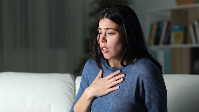 Woman suffering an anxiety attack alone in the night