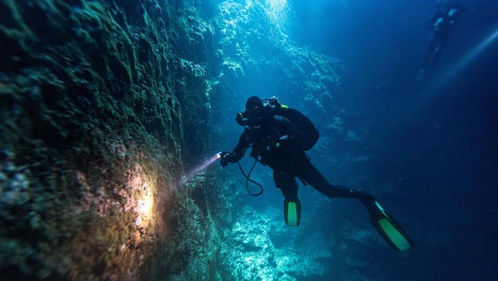 Scuba divers explore an underwater cave at the island of Brac, Croatia, September 2, 2023. REUTERS/Marko Djurica