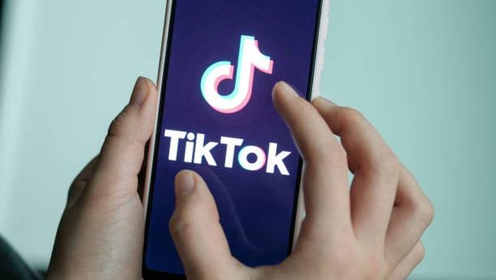 13 November 2019, Berlin: ILLUSTRATION - A girl is holding her smartphone with the logo of the short video app TikTok in her hands. With TikTok, users can create short mobile phone videos to music clips or other videos. Other users can comment on it, distribute hearts or react in any other way. Private messages are also possible. The app is particularly popular with young people. Photo: Jens Kalaene/dpa-Zentralbild/dpa (Photo by Jens Kalaene/picture alliance via Getty Images)