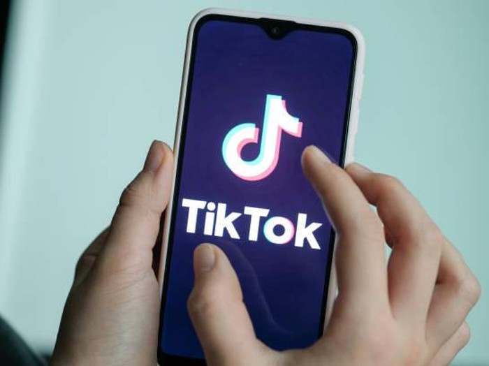 13 November 2019, Berlin: ILLUSTRATION - A girl is holding her smartphone with the logo of the short video app TikTok in her hands. With TikTok, users can create short mobile phone videos to music clips or other videos. Other users can comment on it, distribute hearts or react in any other way. Private messages are also possible. The app is particularly popular with young people. Photo: Jens Kalaene/dpa-Zentralbild/dpa (Photo by Jens Kalaene/picture alliance via Getty Images)